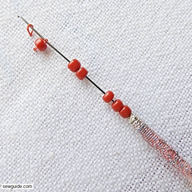 bring up the thread a little distant from the first stitch