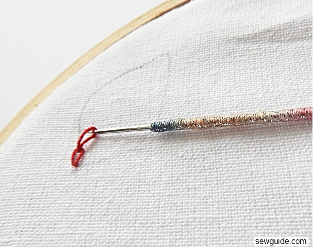 Another loop is brought to the surface with the aari needle