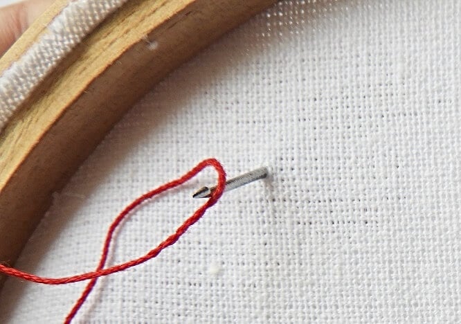 The view from the back of the loop - the tambour needle catching the thread in a loop