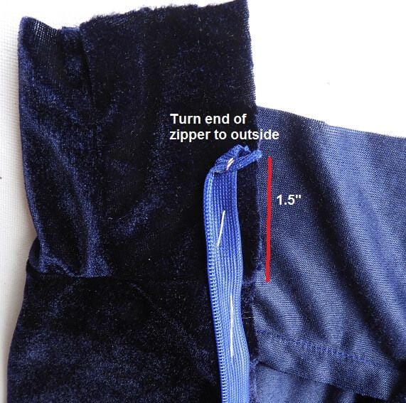 turn the top edge of the zipper down