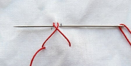 Take another stitch just beneath the first stitch