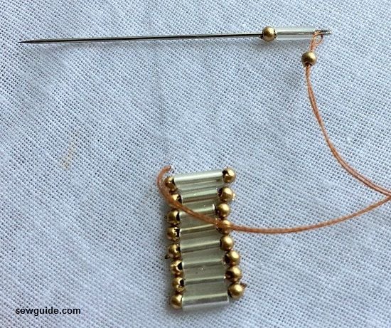 one small bead, one bugle bead and one small bead on the needle.