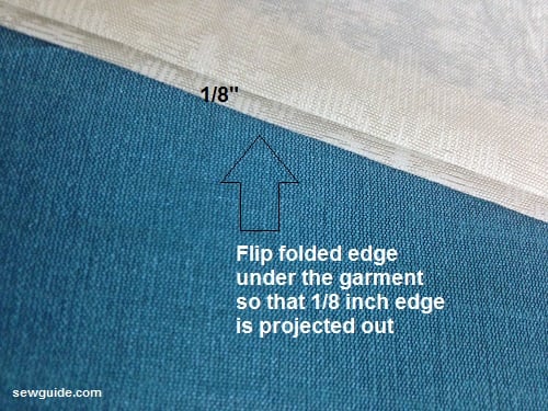 fold the fabric so that 1/8 inch edge projects out to sew the blind hem stitch by hand