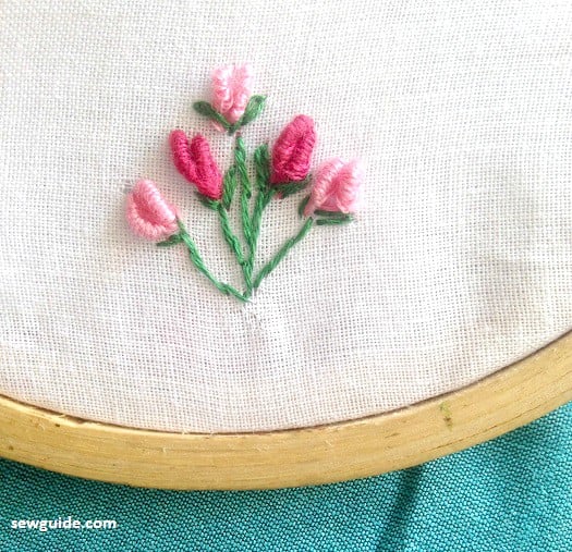 embroider flowers done with bullion stitches ans stem stitches for baby girl dresses