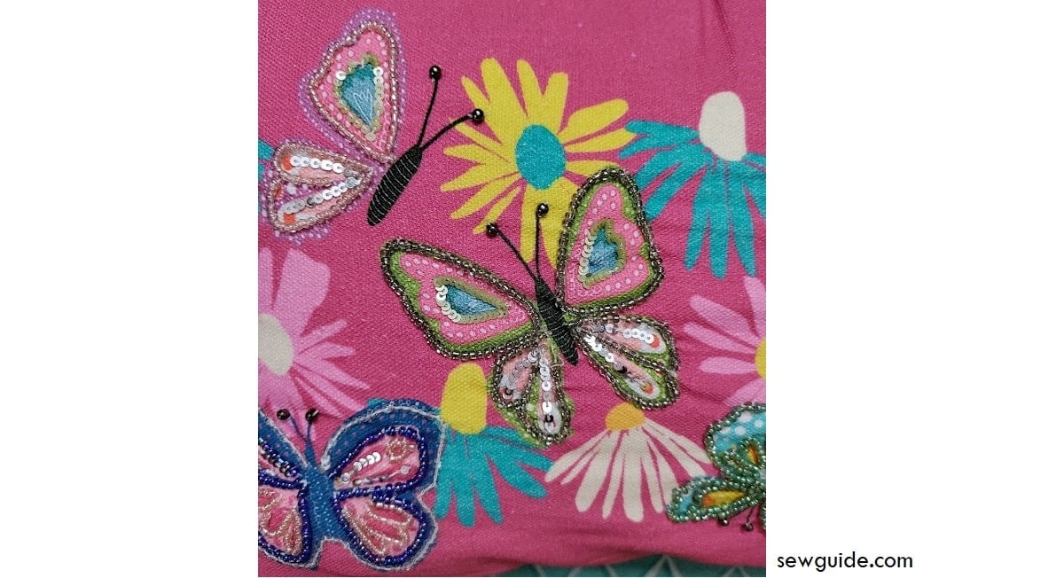 beads embroidered on painted butterfly