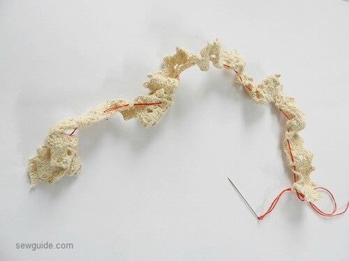 gather lace to attach it over the christmas ornament in fabric