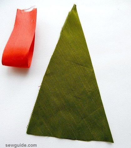cut christmas tree shape triangle from fabric and cut hanger from ribbon