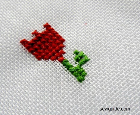 a rose bud with cross stitch