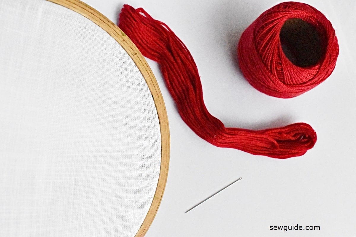 cross stitch supplies materials - thread, fabric, needle.