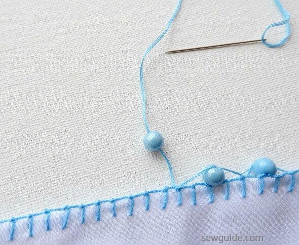 The beads are inserted between the thread loops