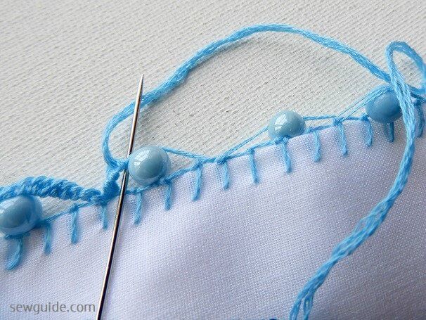 Make loops over the thread loops made along the beads