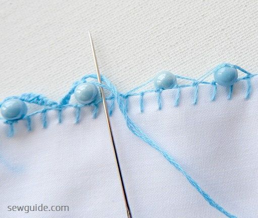 The scallops are formed as a result of the stitches made along the loops