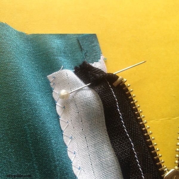 fold the edge of the zipper to the inside