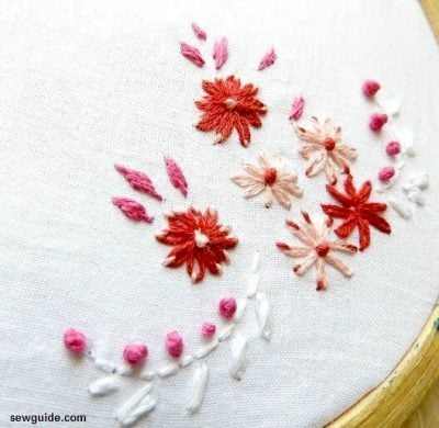 Variation of lazy daisy stitches with different colored thread for the anchor stitch