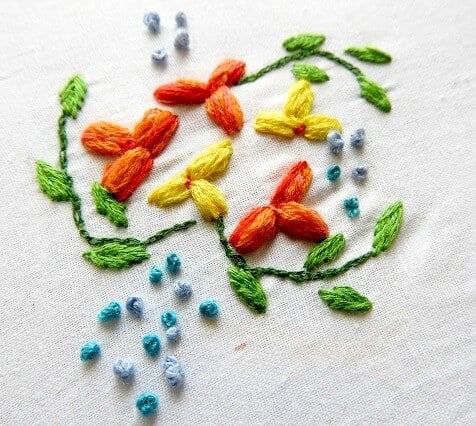 granitos stitch fills the petals and the leaves; french knots are used outside