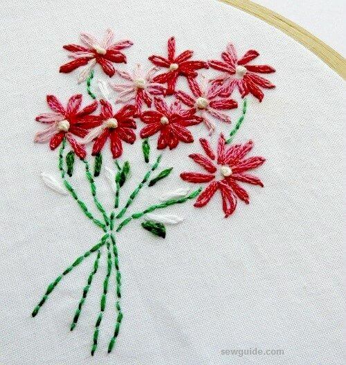 Lazy daisy stitches are used in 2 different colors to make the petals