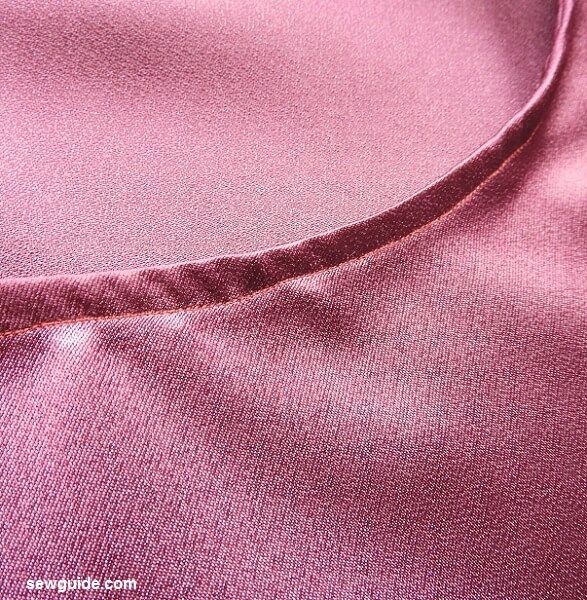 Turn the binding to the back and sew in place