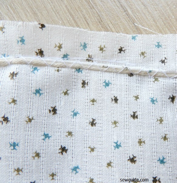 gather the skirt fabric top edge with cord and zig zag stitches