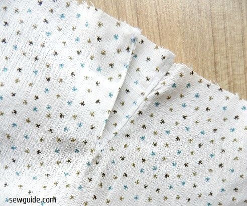 Turn the plackets to the back and sew in place