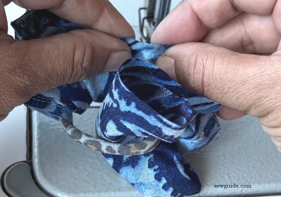 pin the fabric over the hair tie