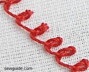 hand embroidery - rosette chain stitch a flower embroidered with a rosette chain stitch