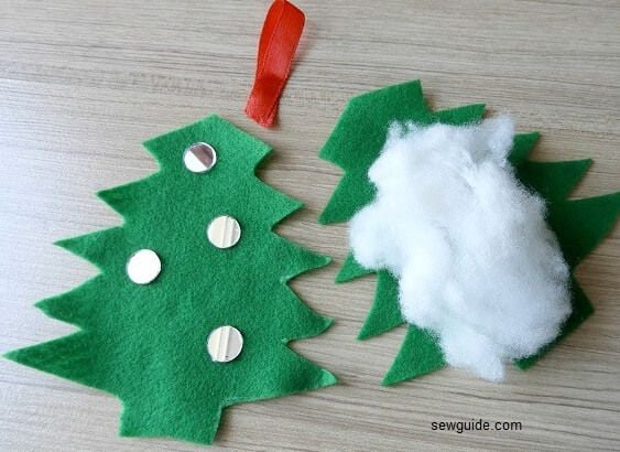 stuff the handmade christmas ornament with cotton and add a hanger made of ribbon