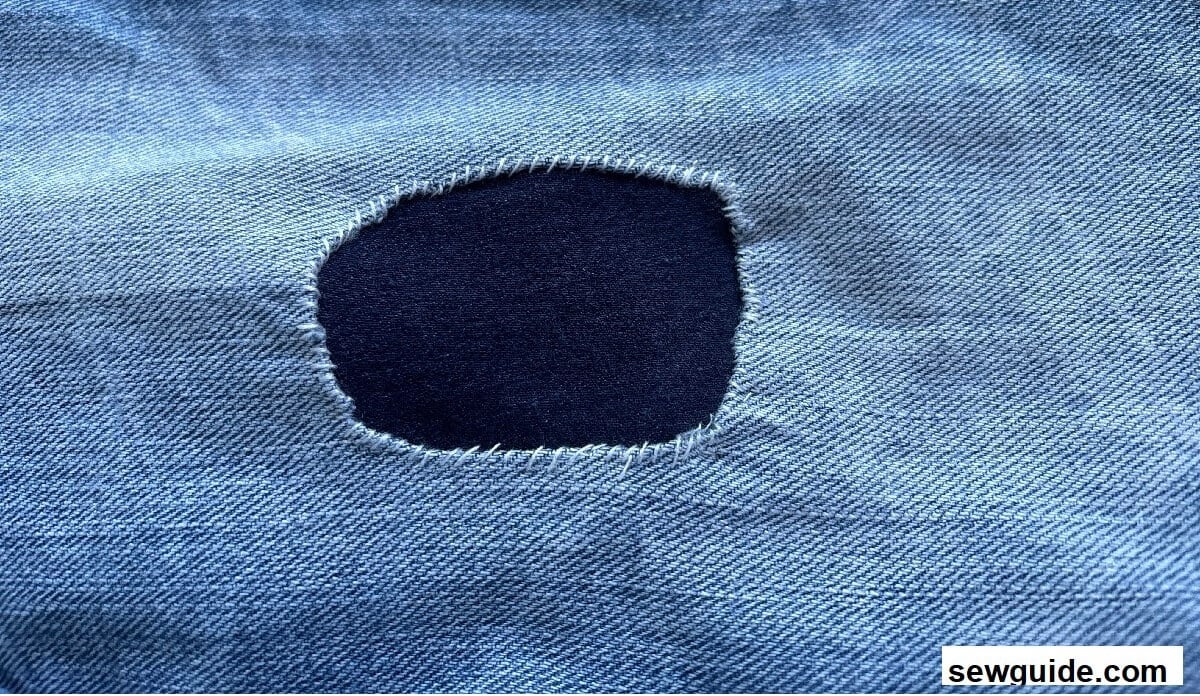 visible mending a hole in jeans