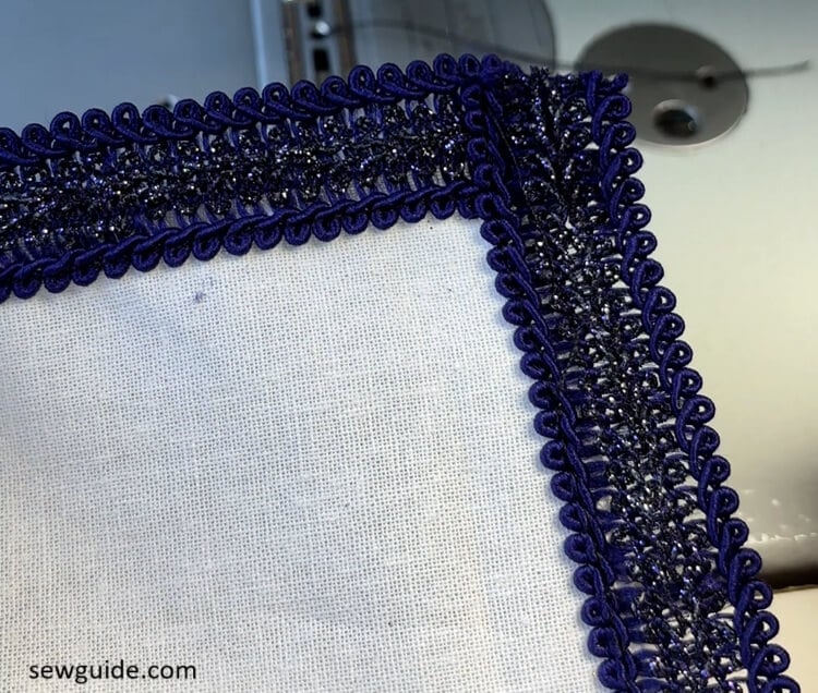 lace trim stitched on top of the edge of the fabric