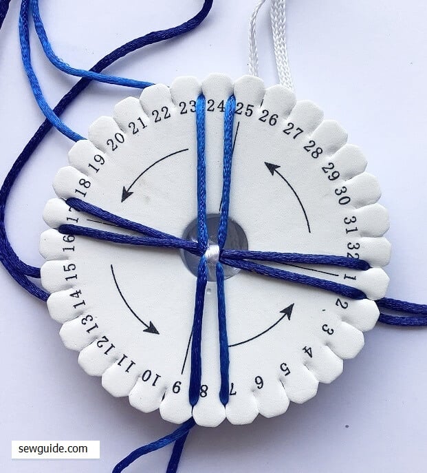 kumihimo thread moved between slots on the disc