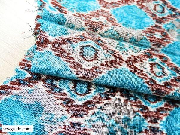 open up the folded fabric and make it look like an inverted pleat