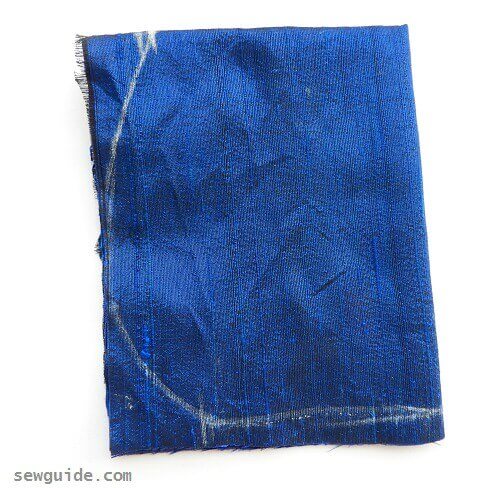 Purse body is cut on a folded fabric