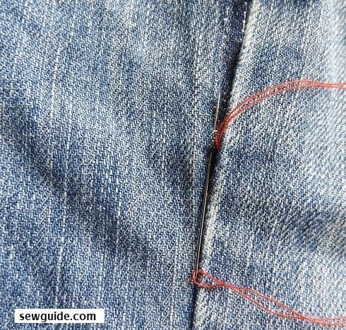 hand sewing a seam from the outside with ladder stitches