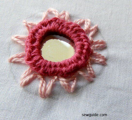 Fly stitch frames the mirror