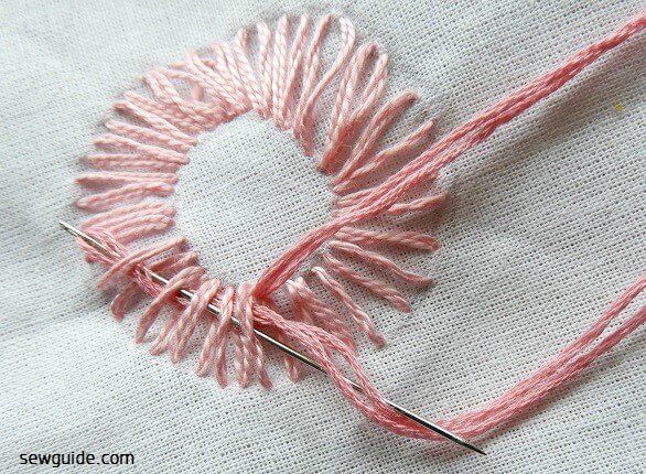 embroidery floss is threaded through the straight stitches
