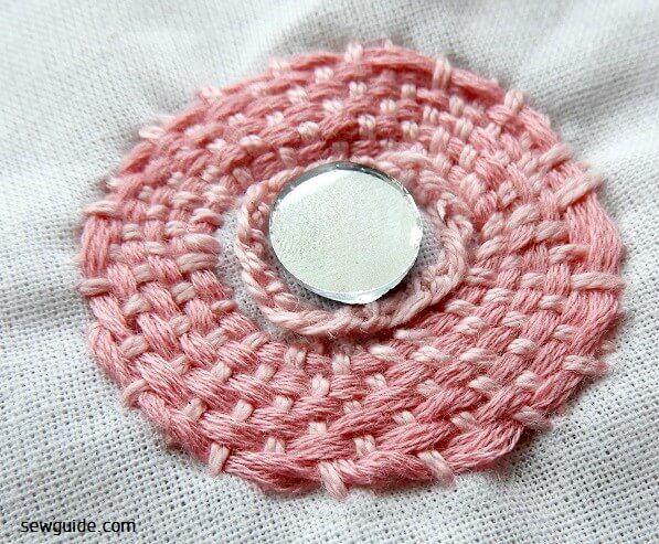 Woven embroidery design over mirror