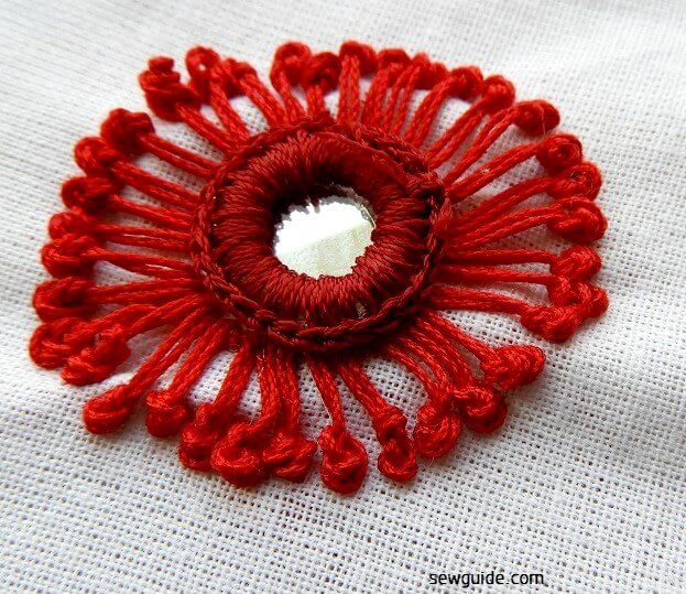 Pistil stitches made over the frame of the mirror