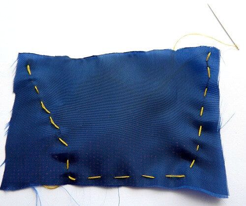 fold the fabric by the middle and make running stitches along the outer edge