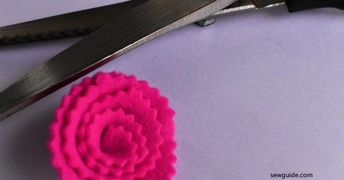 cut felt in the shape of a flower with the pinking shears