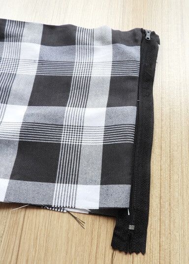 Zipper sewn to one side of the pleated skirt