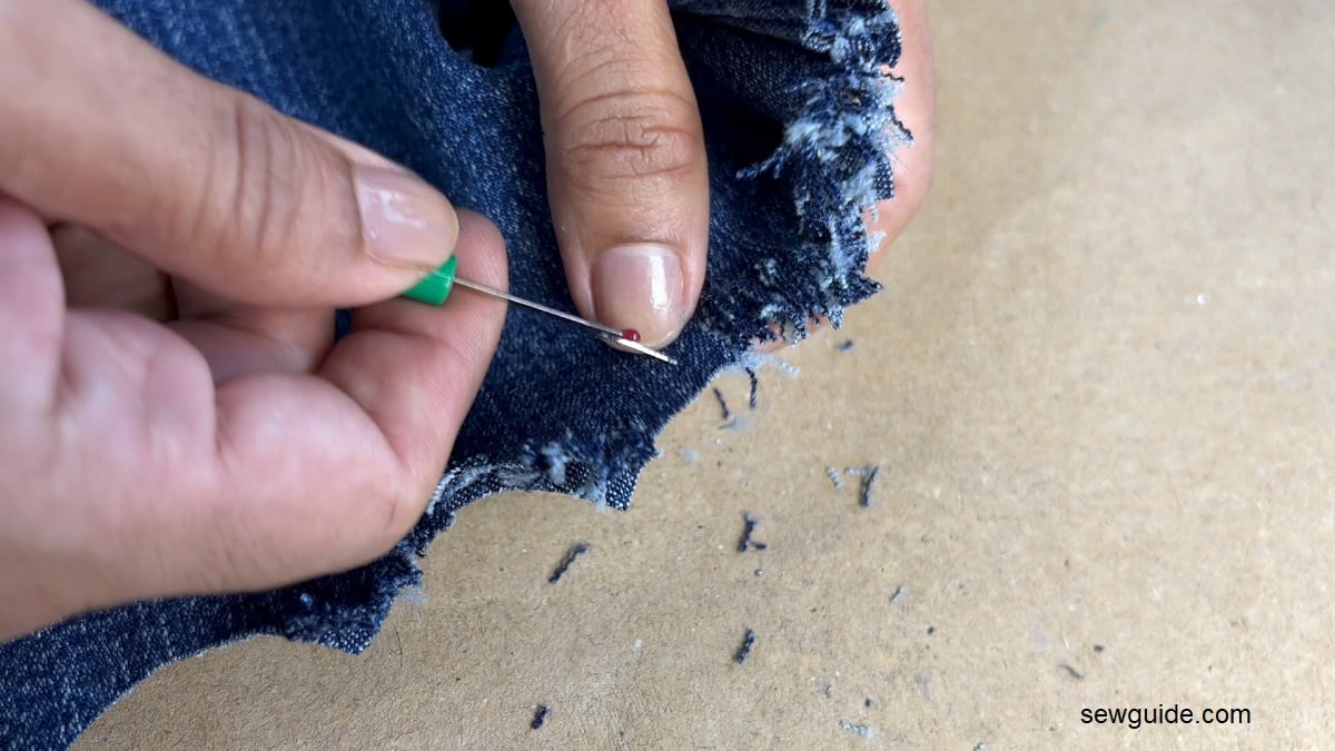 use seam ripper to fray the edge of the jeans