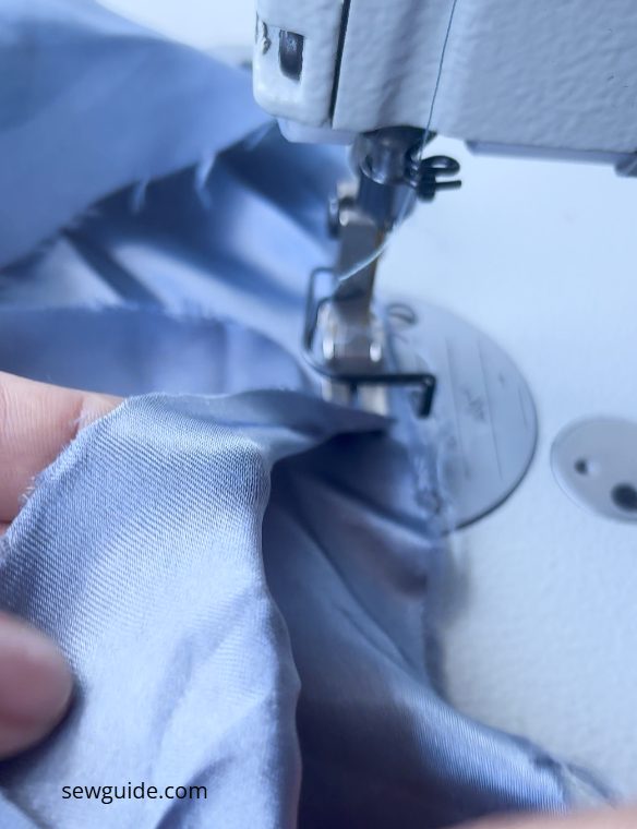 satin fabric- being stitched on