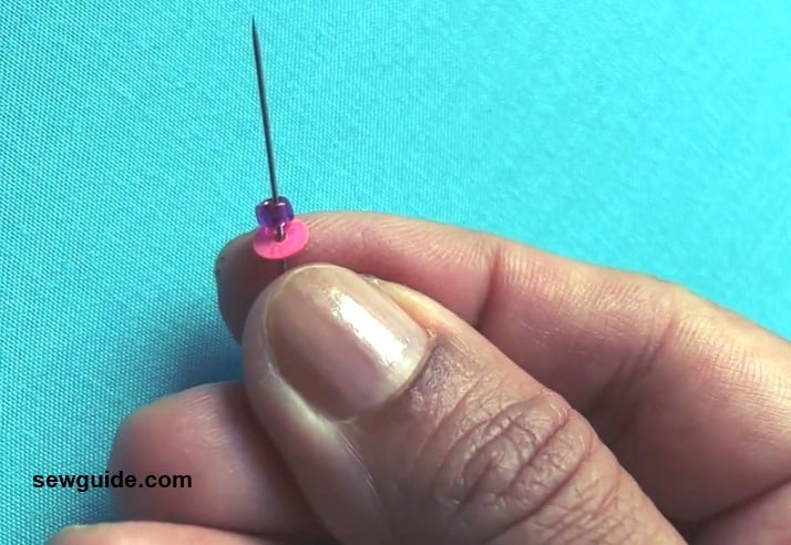 Take up one sequins and a bead on the needle