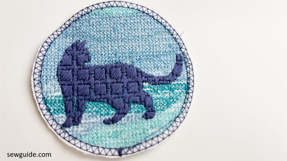 Patch design is cut out without stitching the satin outline