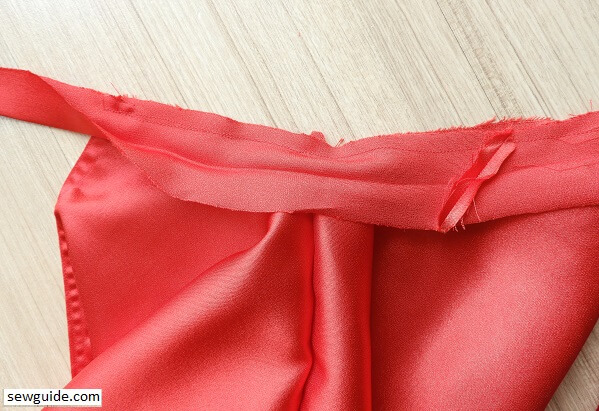 keep the bias tape right side down on the amrhole and sew it to the armhole edge