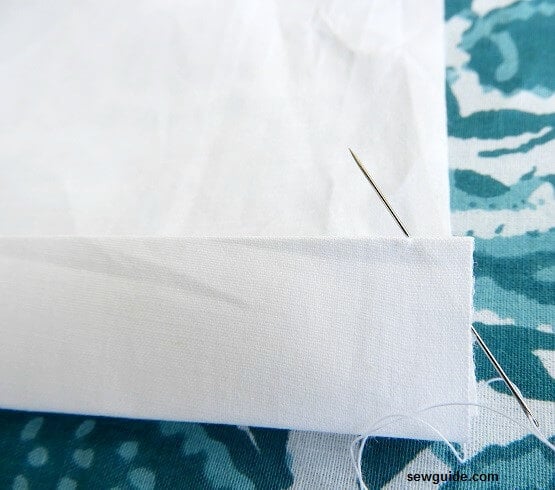 bring out the needle through the fold of the fabric (to hide the knot)