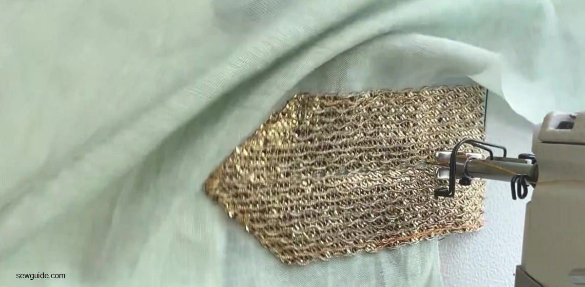 Stitching the trim in place on the neckline