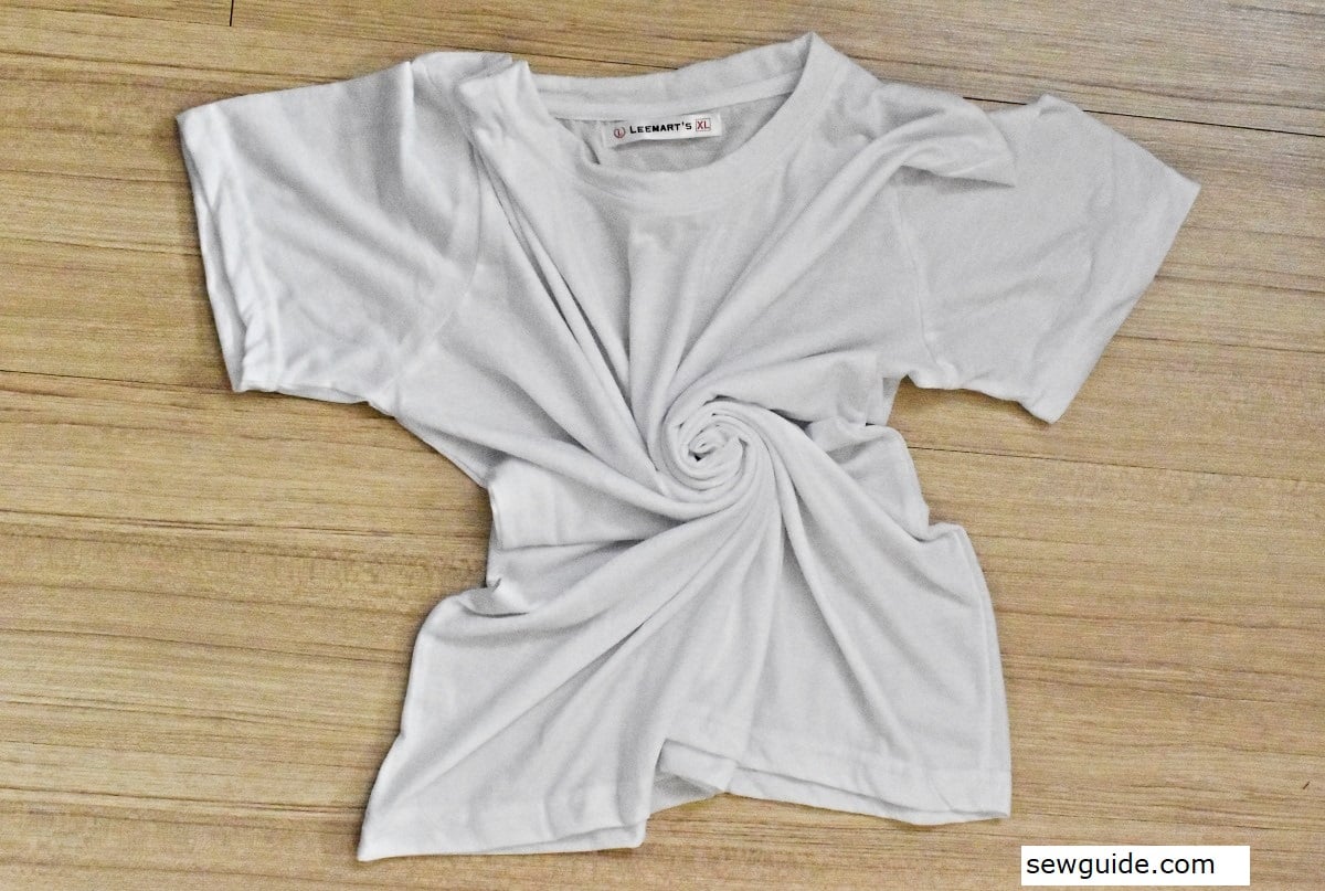 twisting the middle of the t-shirt into a coil for tie dying