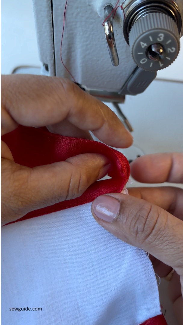 turn ribbon to the back of the napkin